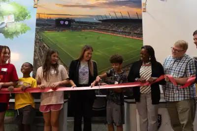 People Cutting a Ribbon to the Louisville City FC and Racing Louisville FC Storefront